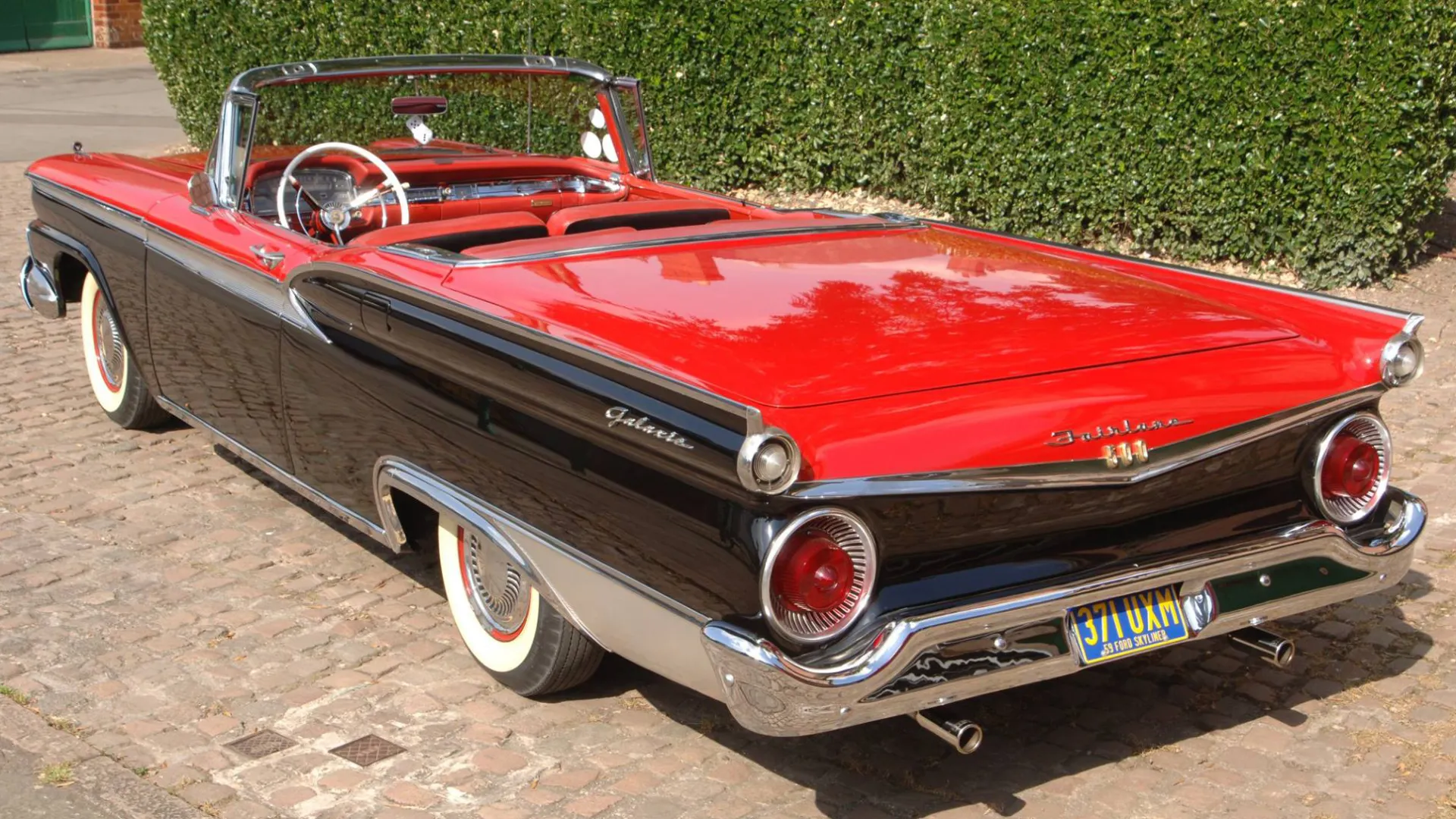 Rear view of American Ford Fairlane in Black with Red Bonnet and boot and convertible roof down