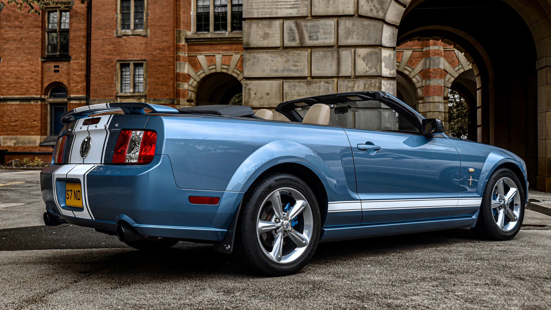 Rear right side view of Ford Mustang with convertible roof open