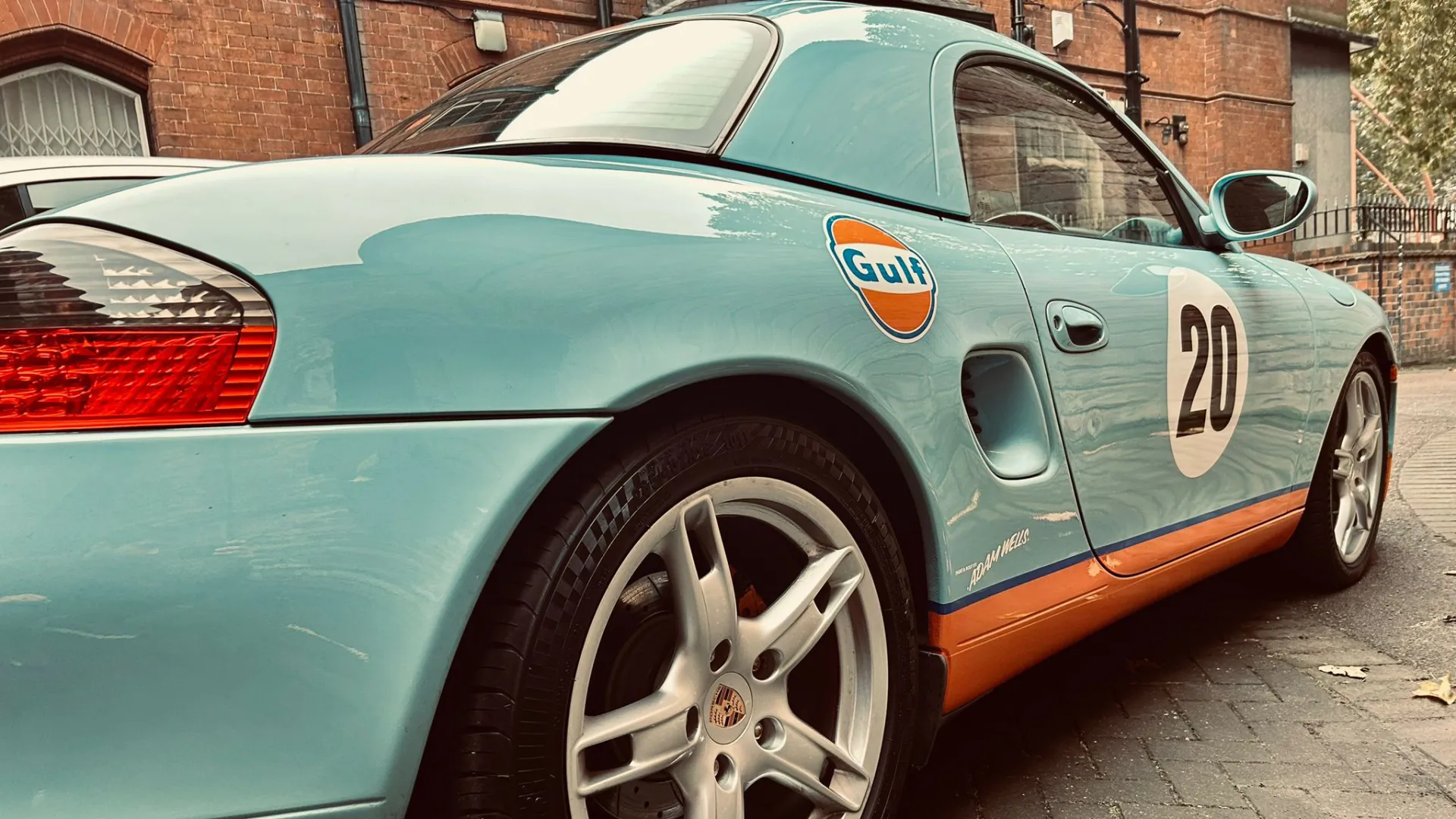 Light blue Porsche Boxster with Orange skirt.