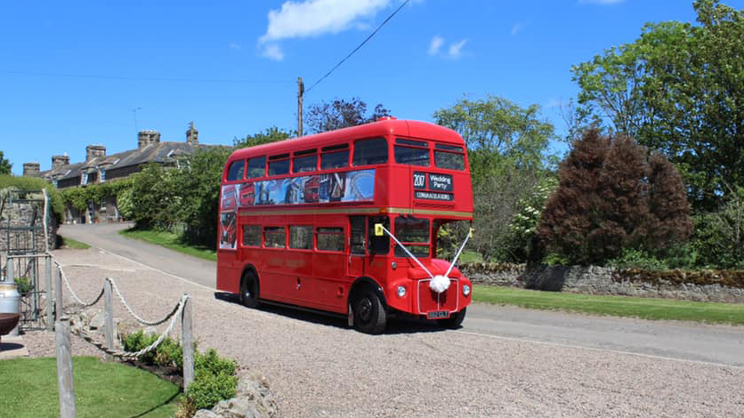 Red Double Decker Bus parked at a wedding venue in Northumberland