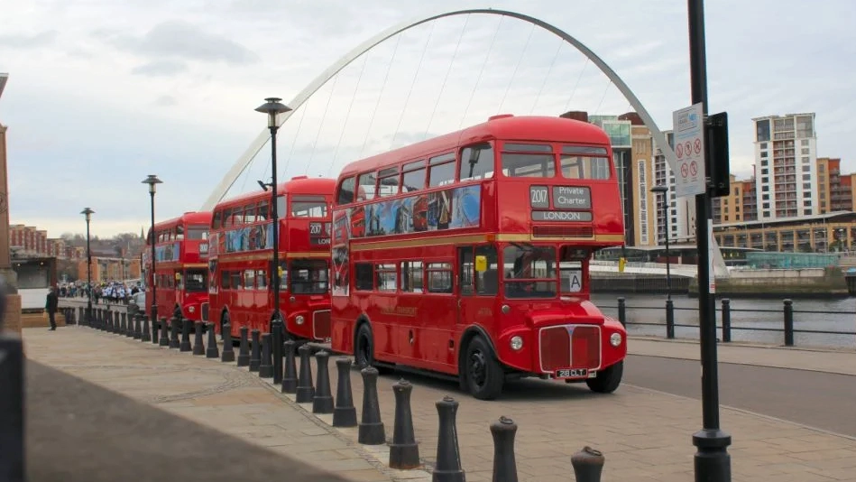 Three identical Red Routemaster vintage Buses parked on the Quay in Newcastle-Upon-Tyne