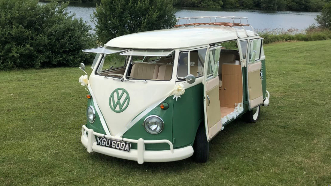 Classic Volkswagen Campervan splitscreen in Green and White with front windows open and rear passenger double doors fully open