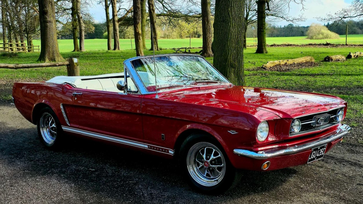 Classic ford Mustang in Red with Chrome Bumper and Convertible roof open