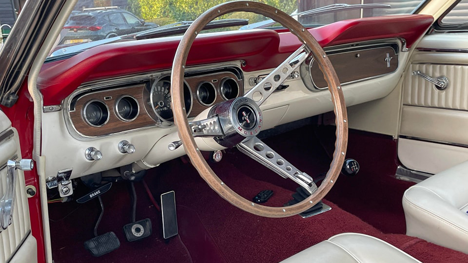 Interior Front Dashboard with white leather interior and burgundy carpet