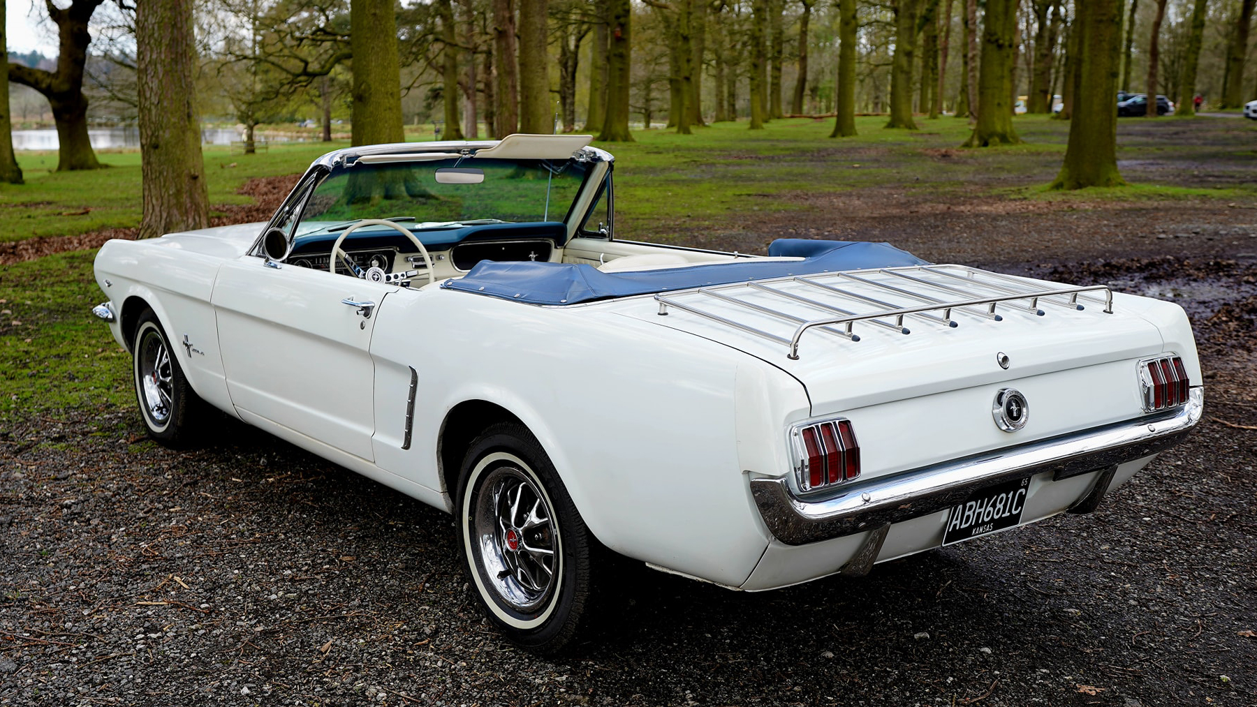 Rear view of White Classic Ford Mustang with roof down