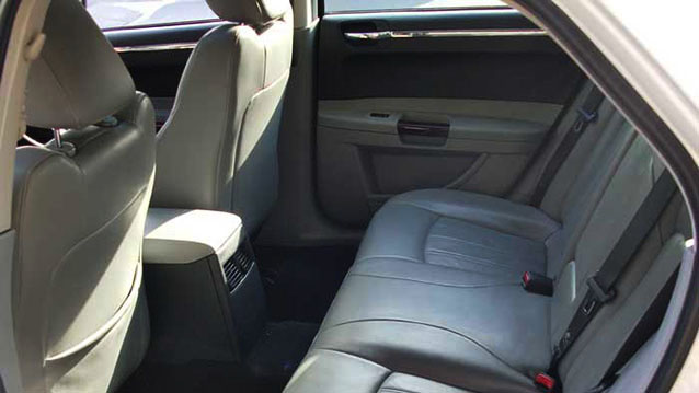 Grey leather rear interior seats inside Chrysler 300c saloon car.