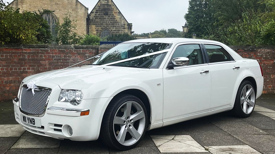 White Chrysler 300c Saloon Car with white weding ribbons