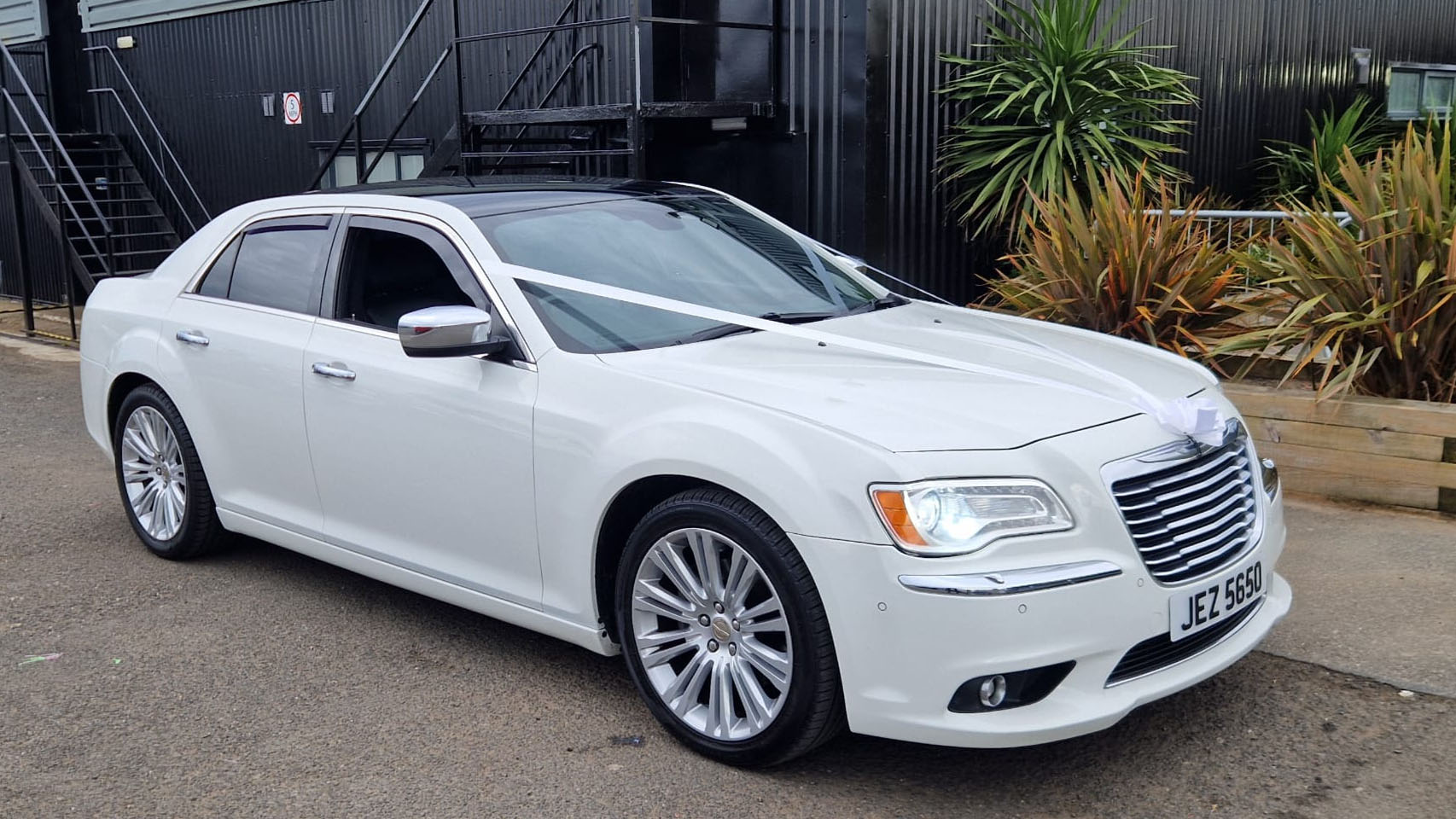 Chrysler 300c Car in white dressed with white wedding ribbons