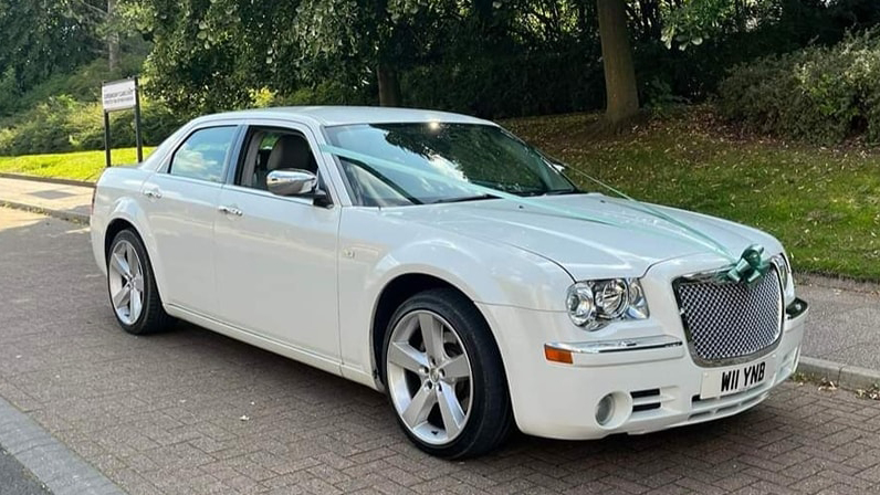 White Chrysler 300c Saloon Car with white ribbons and Royal Blue Bow