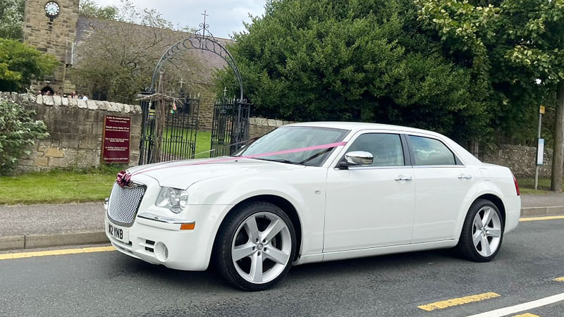 White Chrysler 300c Saloon Car at a church in Durham