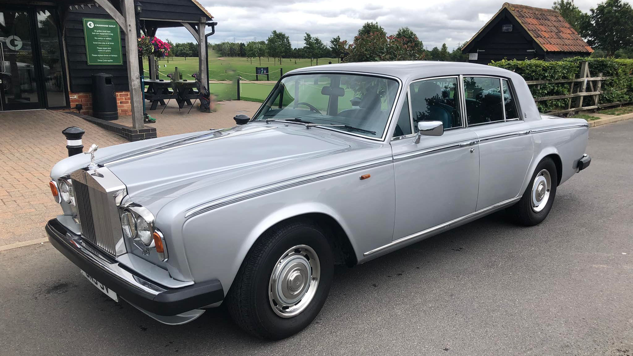 Rolls-Royce Silver Shadow in silver parked in front of Gold Club in Brentwood