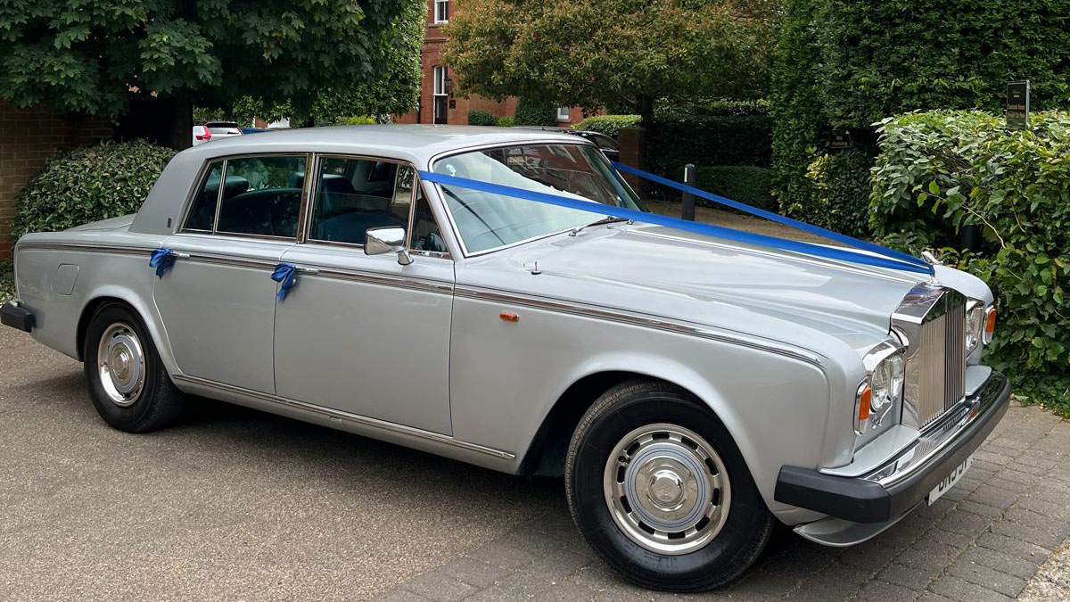 Silver Rolls-Royce Silver Shadow with Royal blue ribbons and bows on door handles