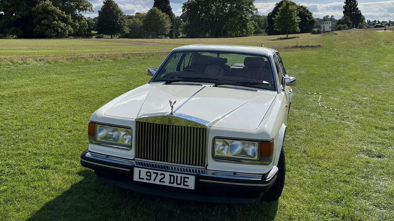 front view of classic Rolls-Royce Silver Spirit with large chrome grill and spirit of ecstasy seating a top