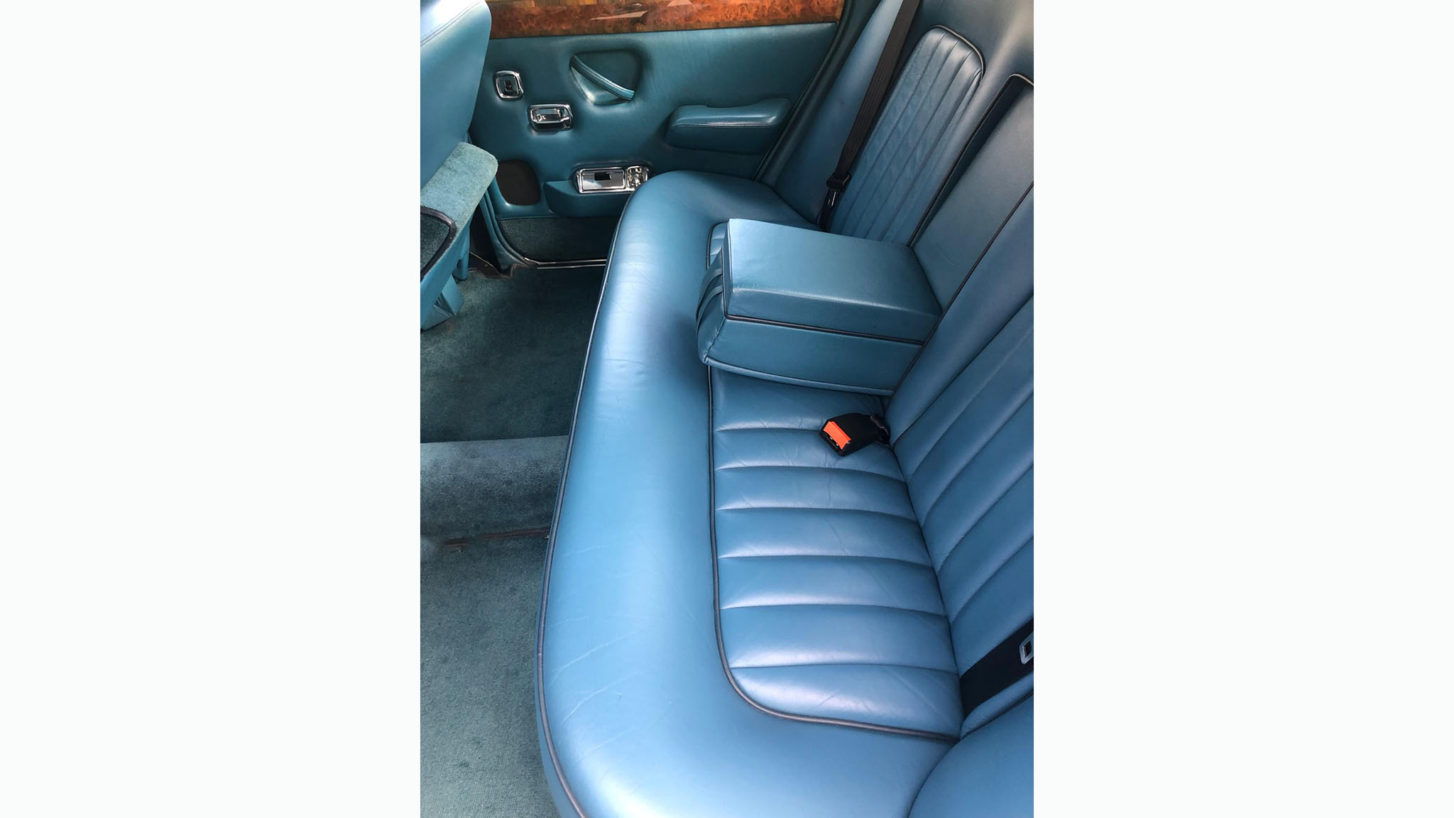 BLue leather interior bench seat inside a Rolls-Royce Silver Shadow