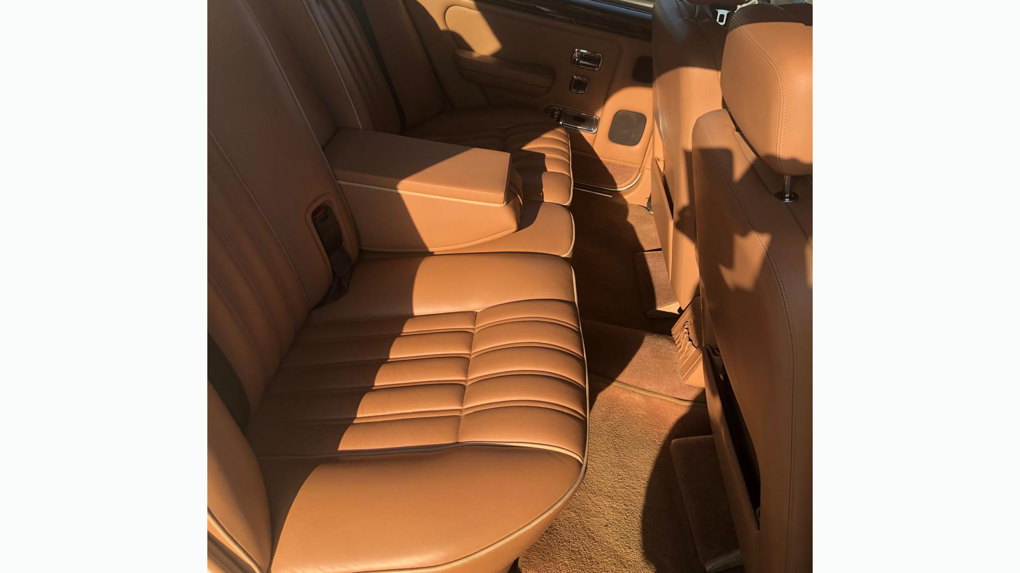 tan leather interior rear bench seat inside a classic Rolls-Royce