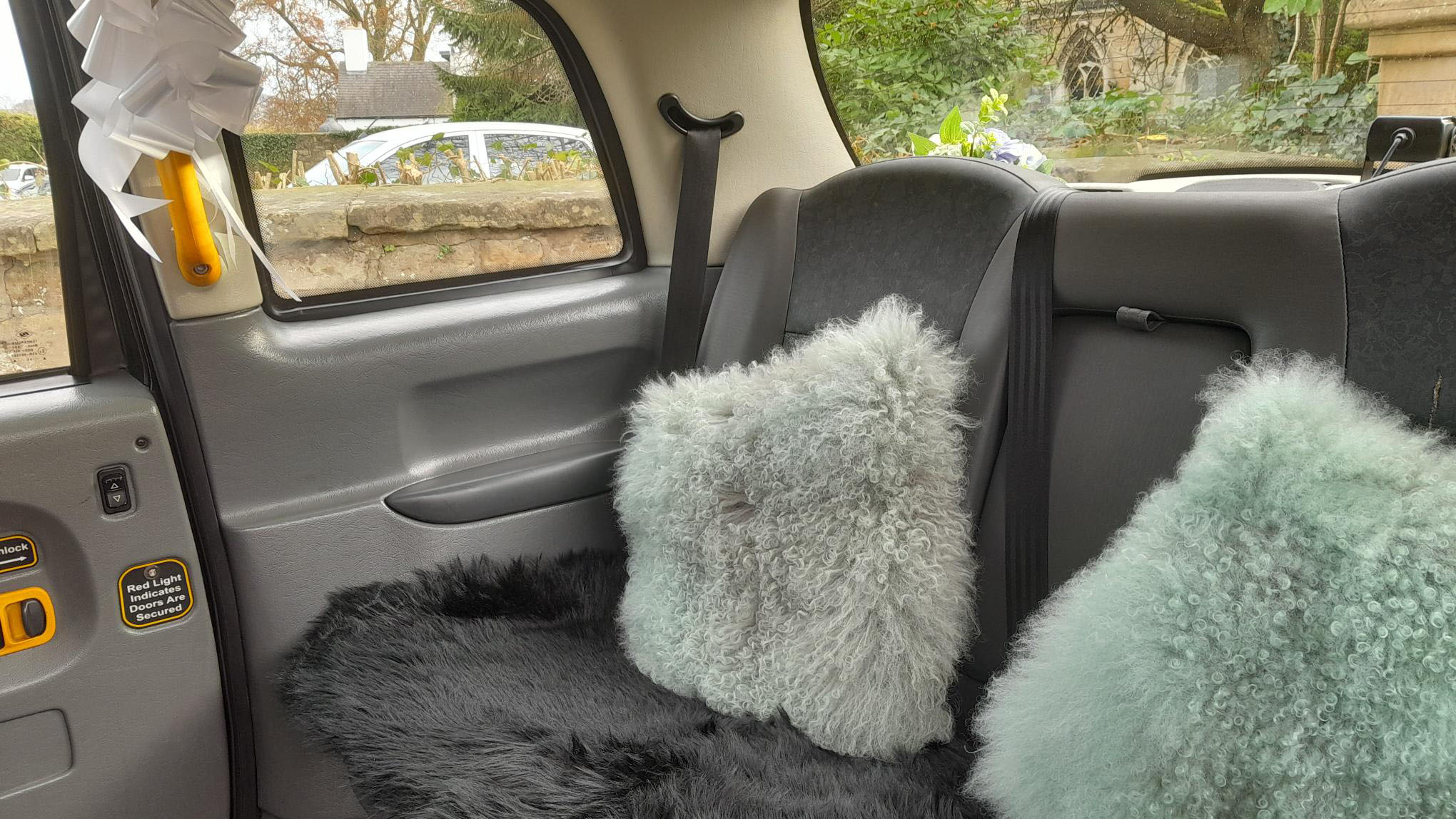 Grey interior of a Modern Taxi cab with two fluffy cushions