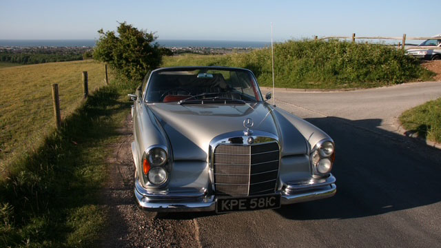 Classic silver Mercedes parked on the rural road of Sussex