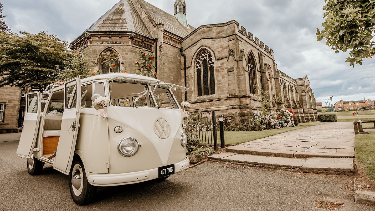 front right view of classic campervan with rear double doors open parked in front of a church in Nottingham