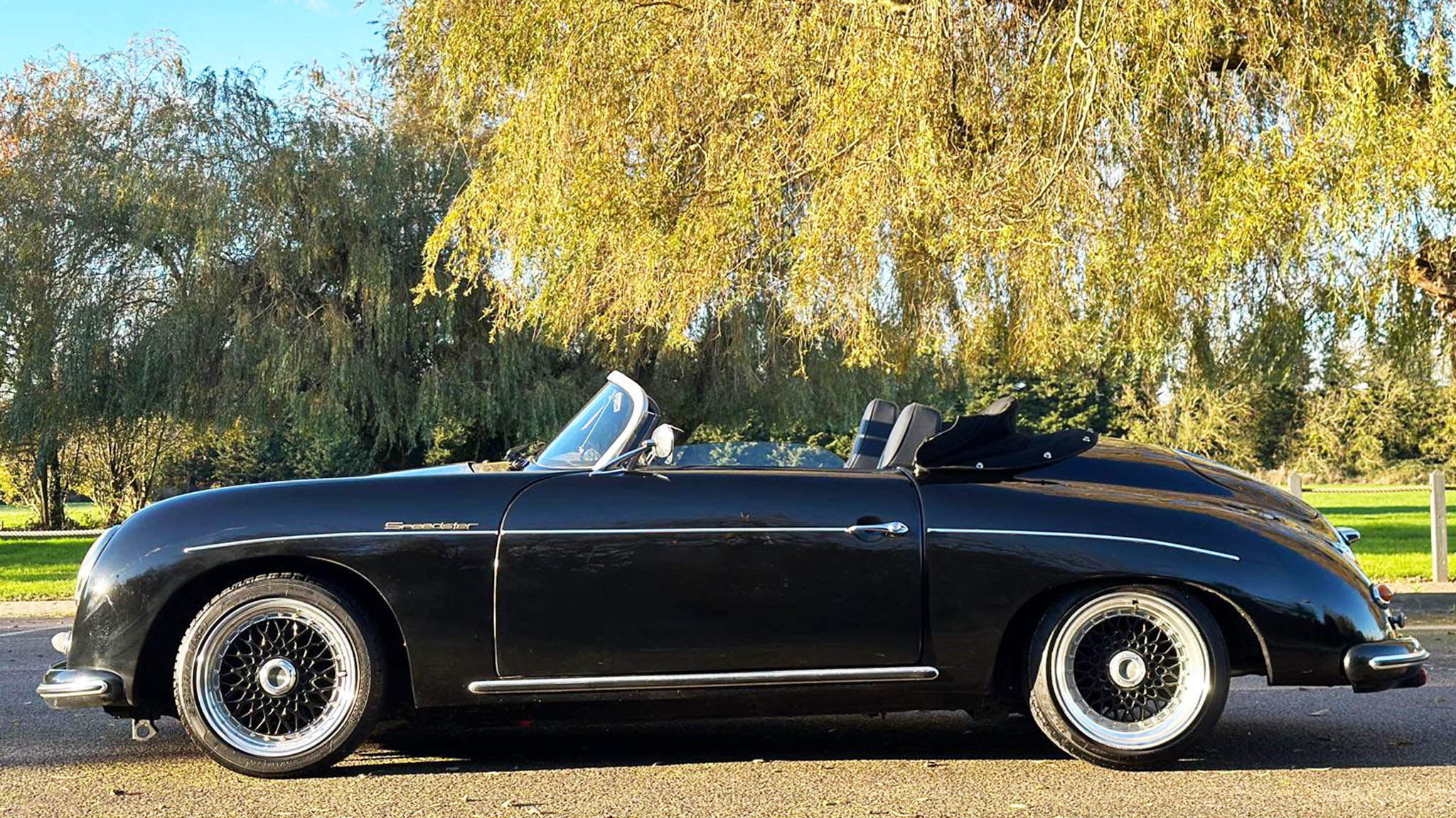 Left side view of a Black Convertible Porsche