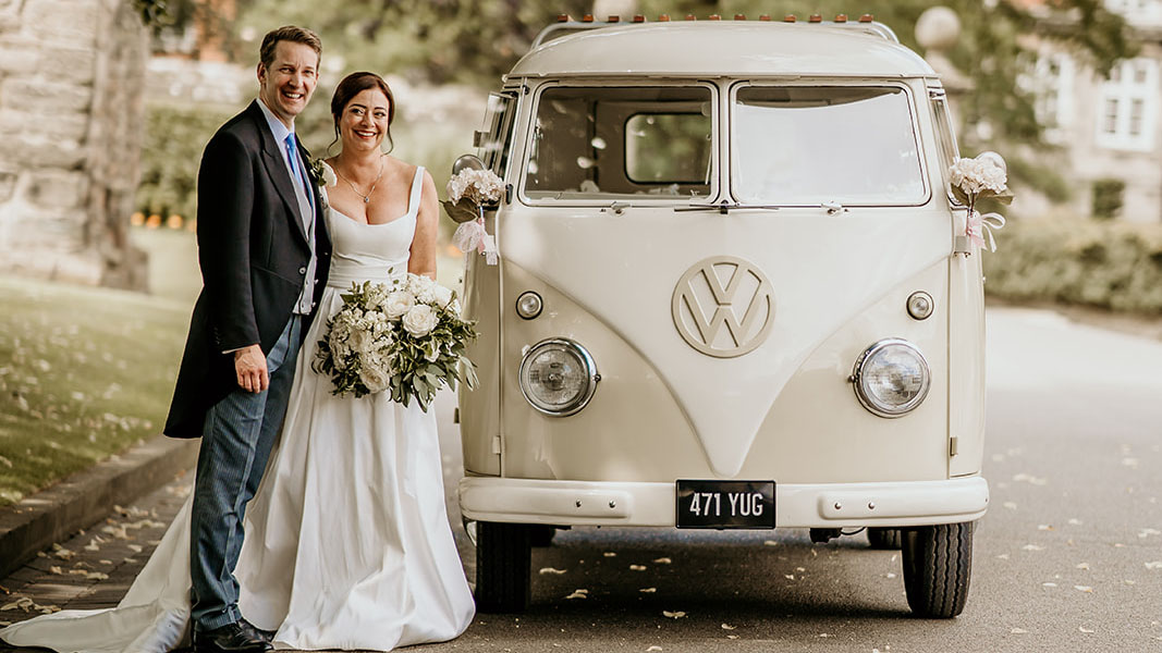 Bride and groom with classic VW campervan