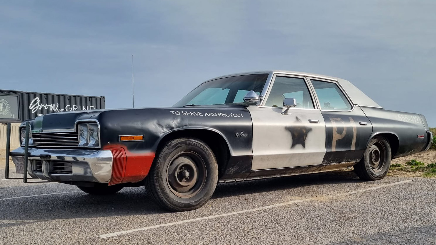 Left side view of the Bluesmobile Dodge Monaco with with moview features with washed out sheriff star, dented front wing.