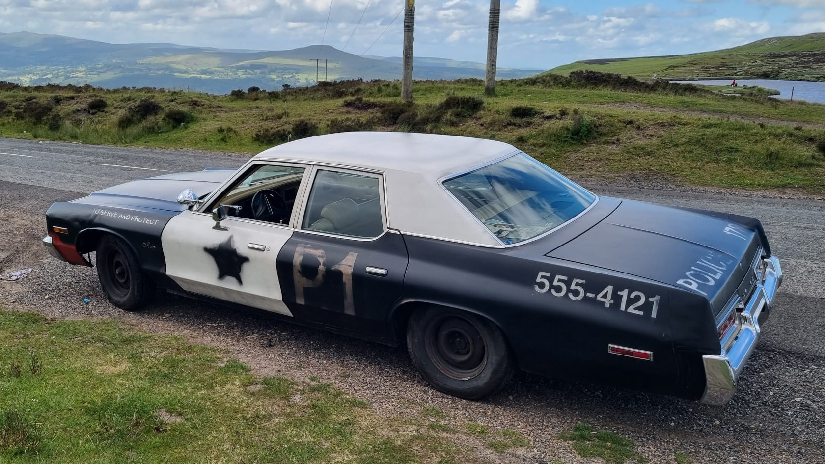 Aerial rear view of the Bluesmobile sheriff car in Black and White