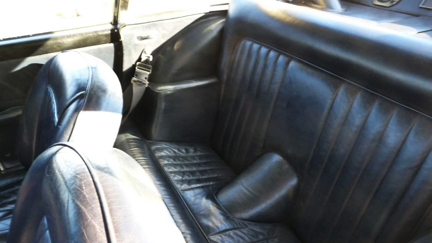 Black leather rear interior inside a classic Astoin Martin DB5