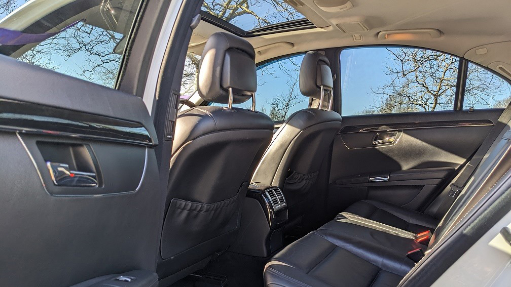 Black leather interior inside Mercedes with view of sunroof