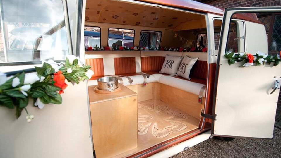 Rear passenger double door open showing leather interior in Burnt orange and white matching the exterior of the classic campervan