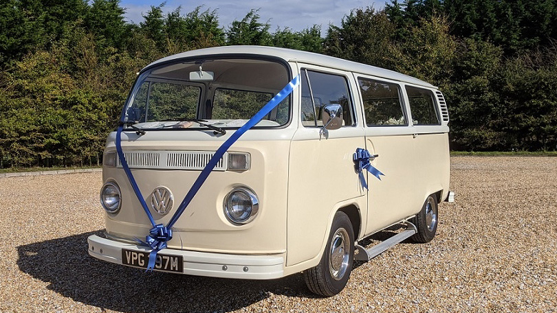 Ivory and Cream classic VW Campervan decorated with royal Blue ribbons and bows