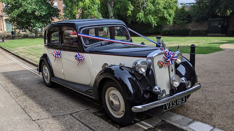 Rover p3 wedding car dressed with pink ribbons