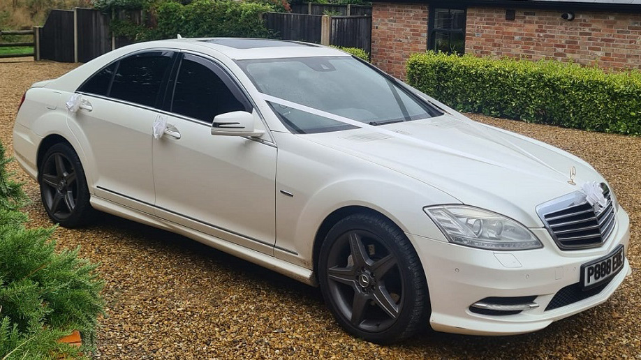 white Mercedes with white ribbons