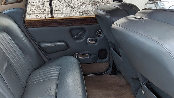 Dusty Blue rear leather interior in classic Rolls-Royce with wooden door tops, vanity mirror