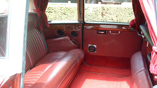 Burgundy leather seats and carpet in rear compartment of a classic Daimler DS420 limousine