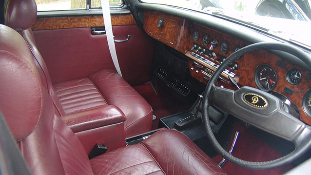 Front interior with Burgundy leather seats and wooden dashboard