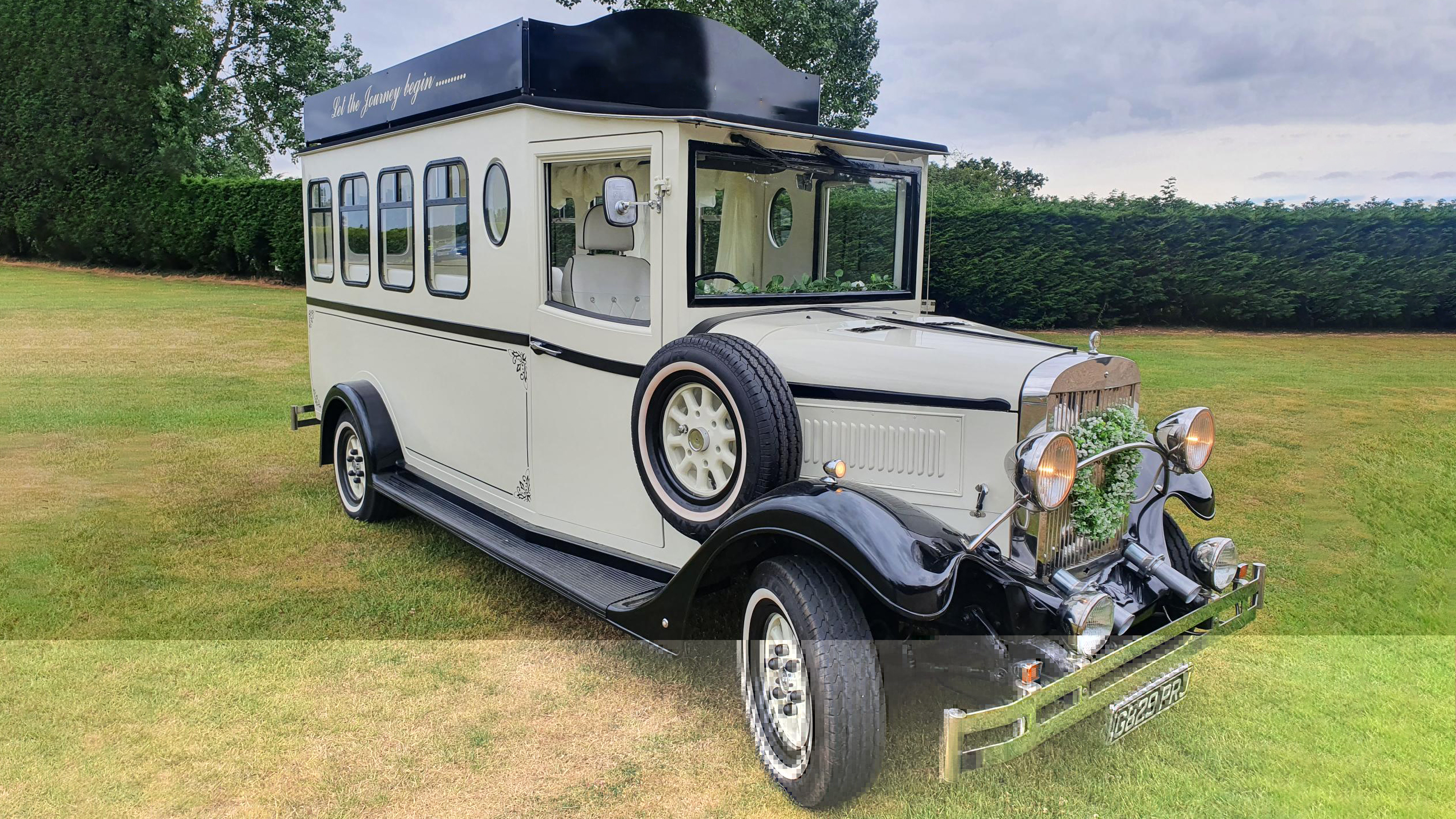 Black & Ivory Asquith Vintage Style Bus with spare wheel mounted on the side, large passengers windows at the rear