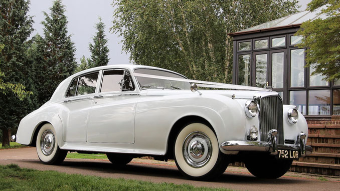 Right side view of Classic Bentley S1 dressed with white ribbons