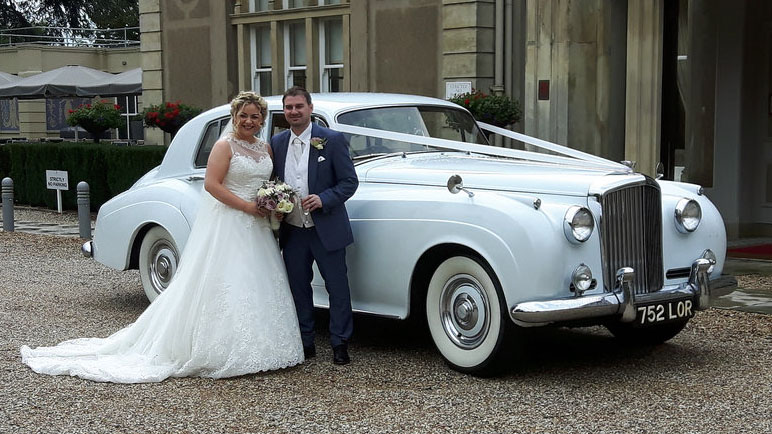 Bride and Groom in front of a classic White Bentley