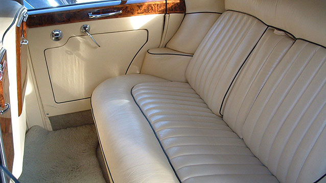 Rearinterior inside a Classic Bentley with cream leather interior