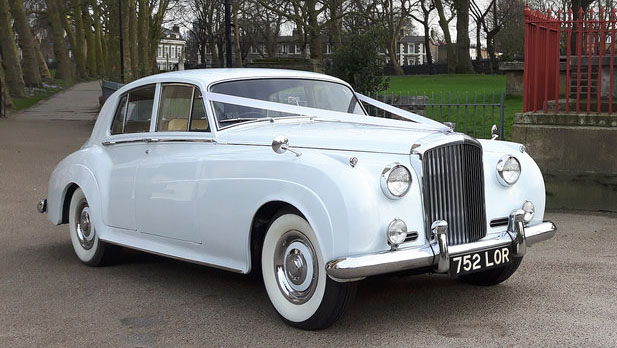 White Classic Bentley S1 with large chrome front grill and wedding ribbons