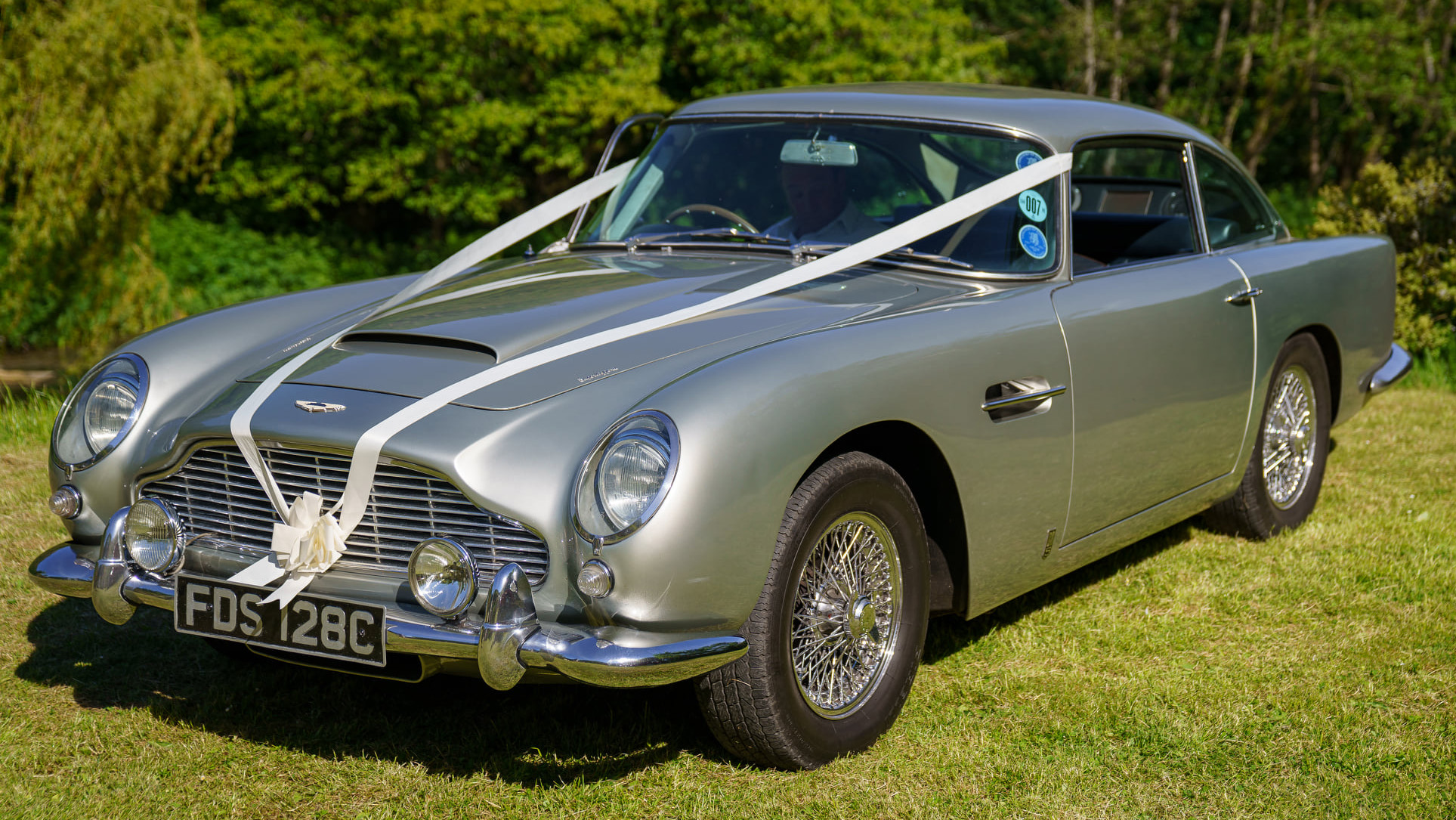 Classic Aston Martin DB5 in Silver dressed with white wedding ribbons