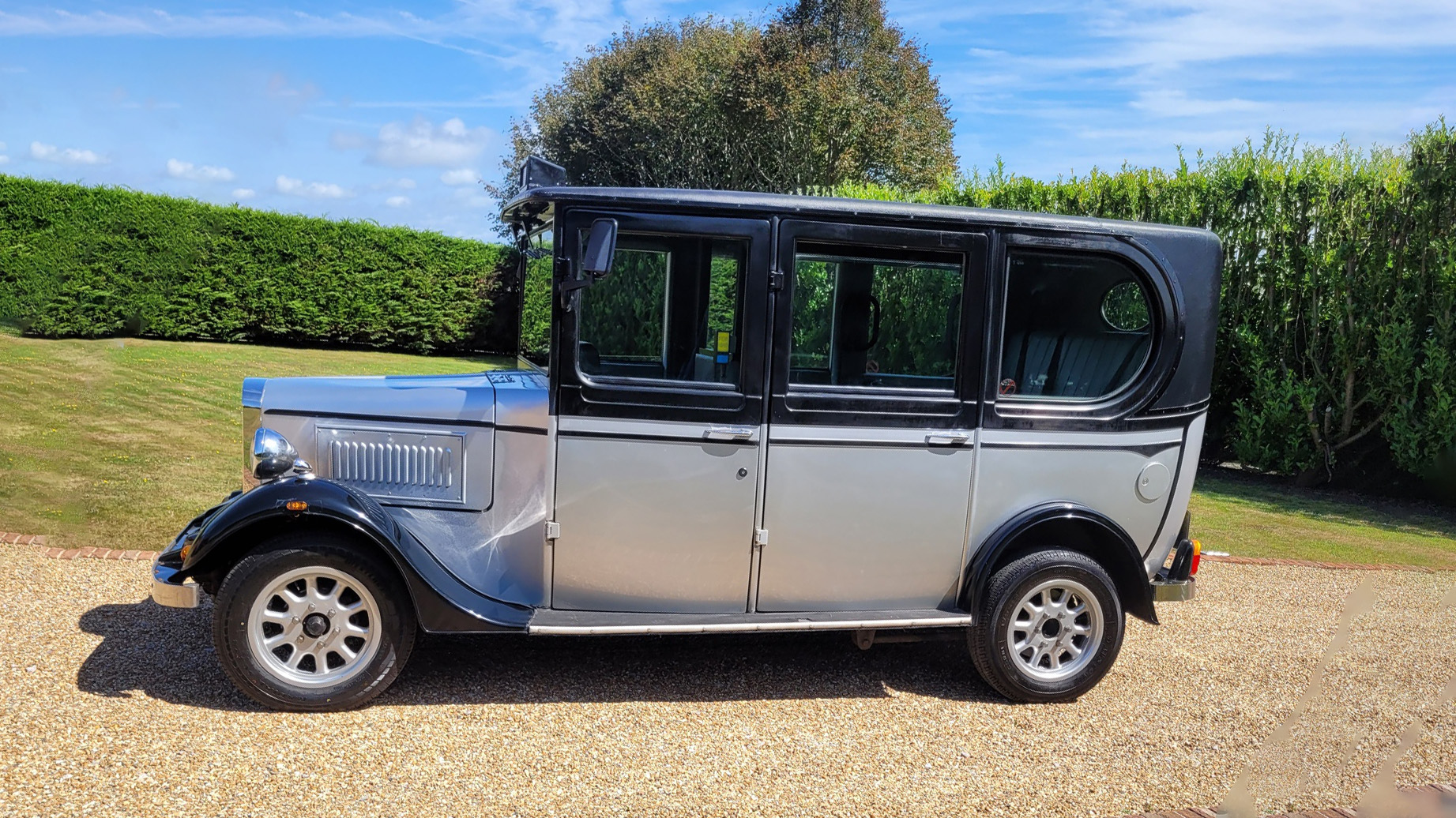 Left side view of silver and black Asquith Taxi