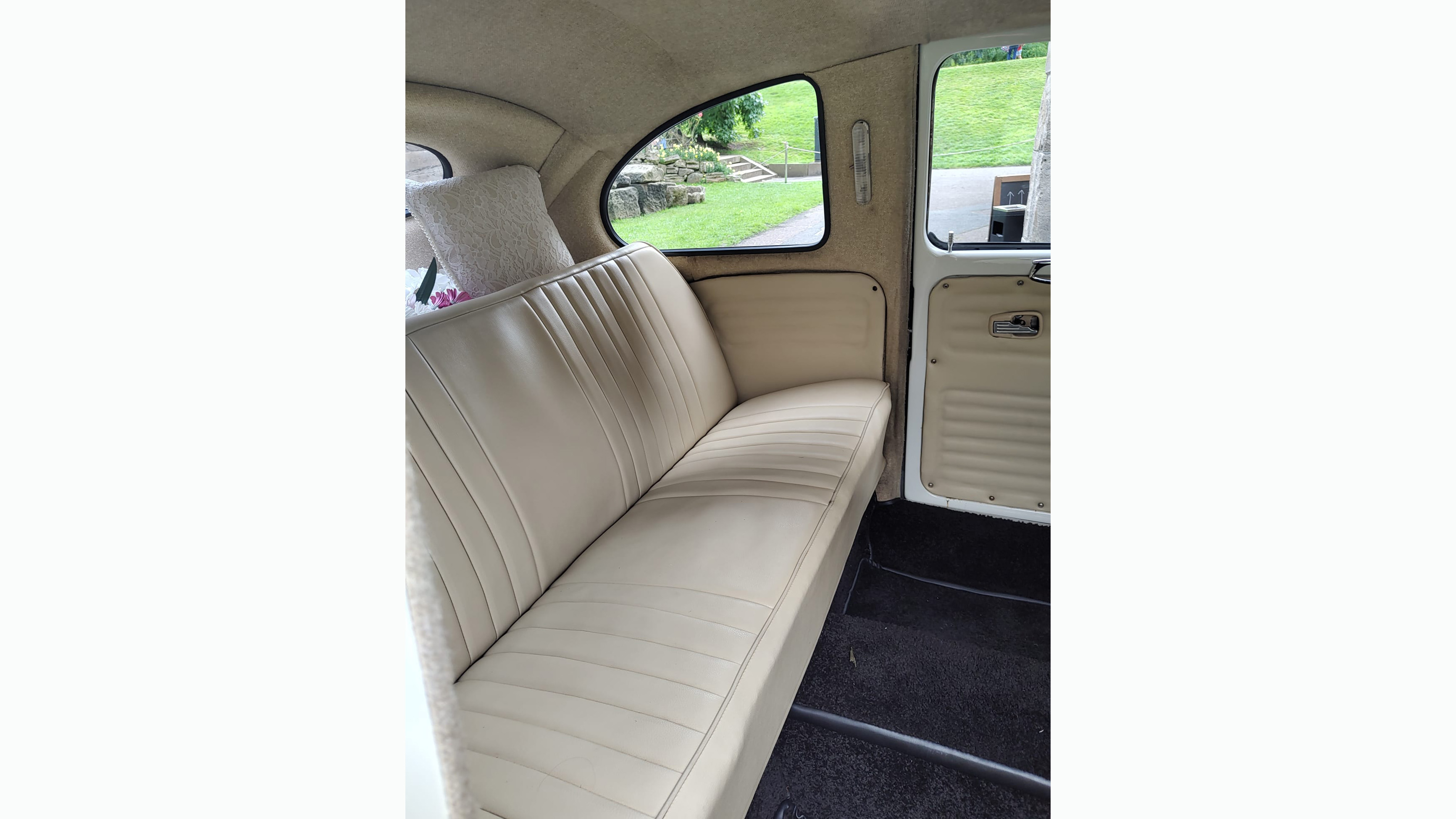 Rear cream leather bench seat inside stretched Beetle Limo.