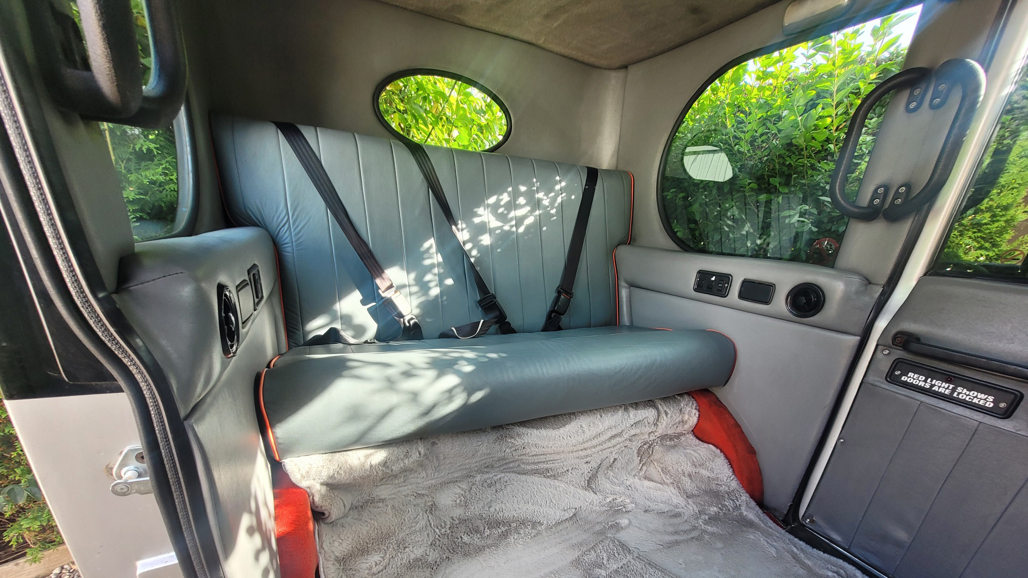 vintage style Asquith interior with Leather seats and seat belts.