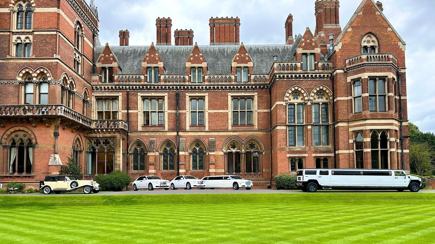 Five wedding cars parked in front of Kalham Hall in Newark, Nottinghamshire. From left to right: Vintage Beauford in Ivory with Black Roof, two White Rolls-Royce Ghost, a white Stretched Limousine and a White Stretched Hummer.