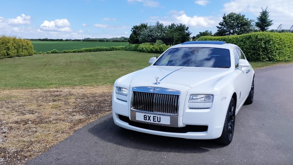 White rolls-royce ghost with front chrome grill