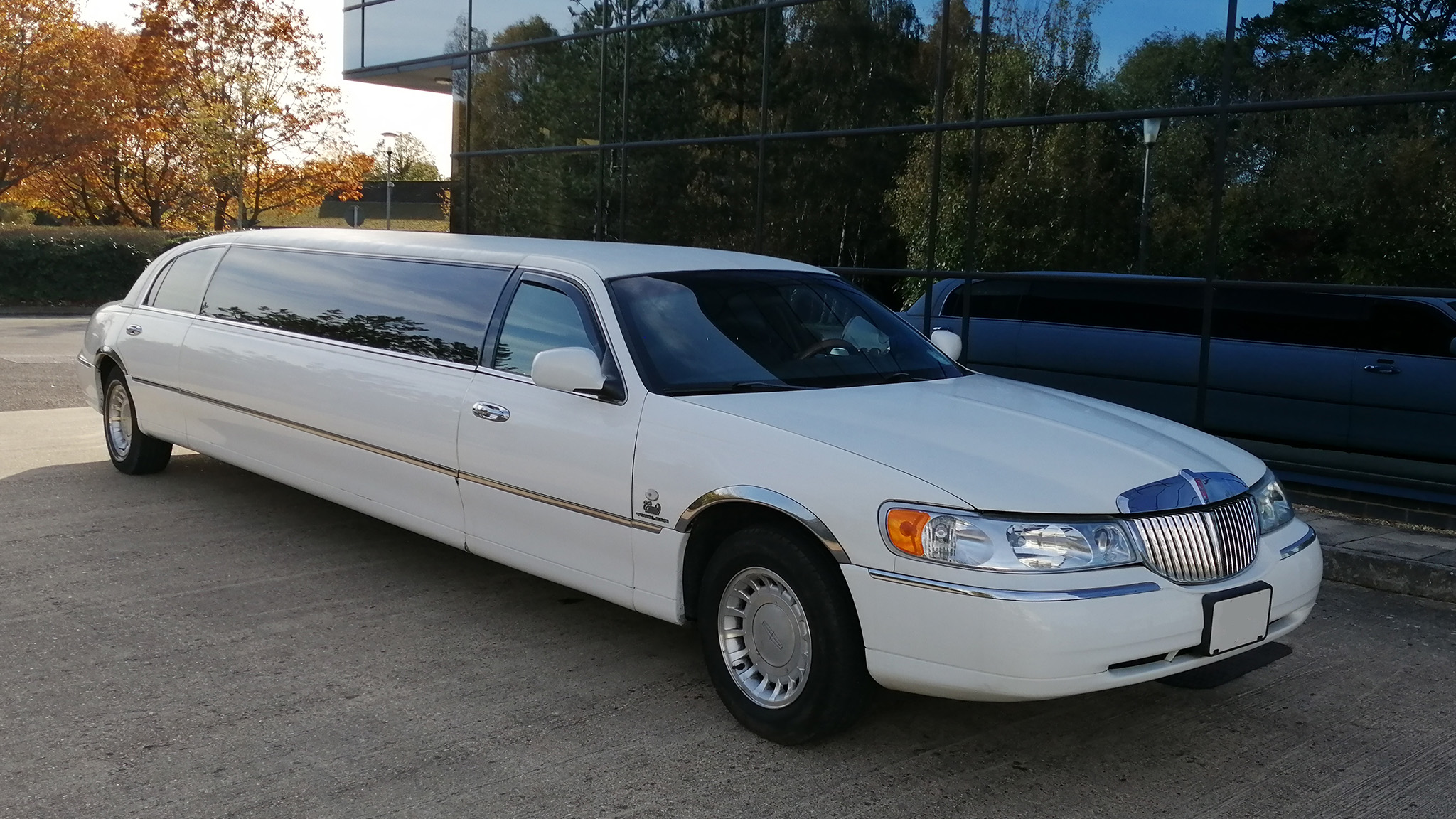 Right side view of a white modern stretched limousine