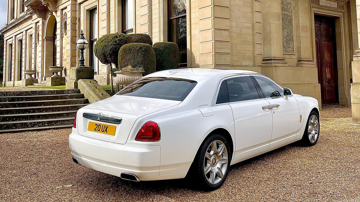 rear right view Rolls-Royce Ghost with large chrome alloy wheels