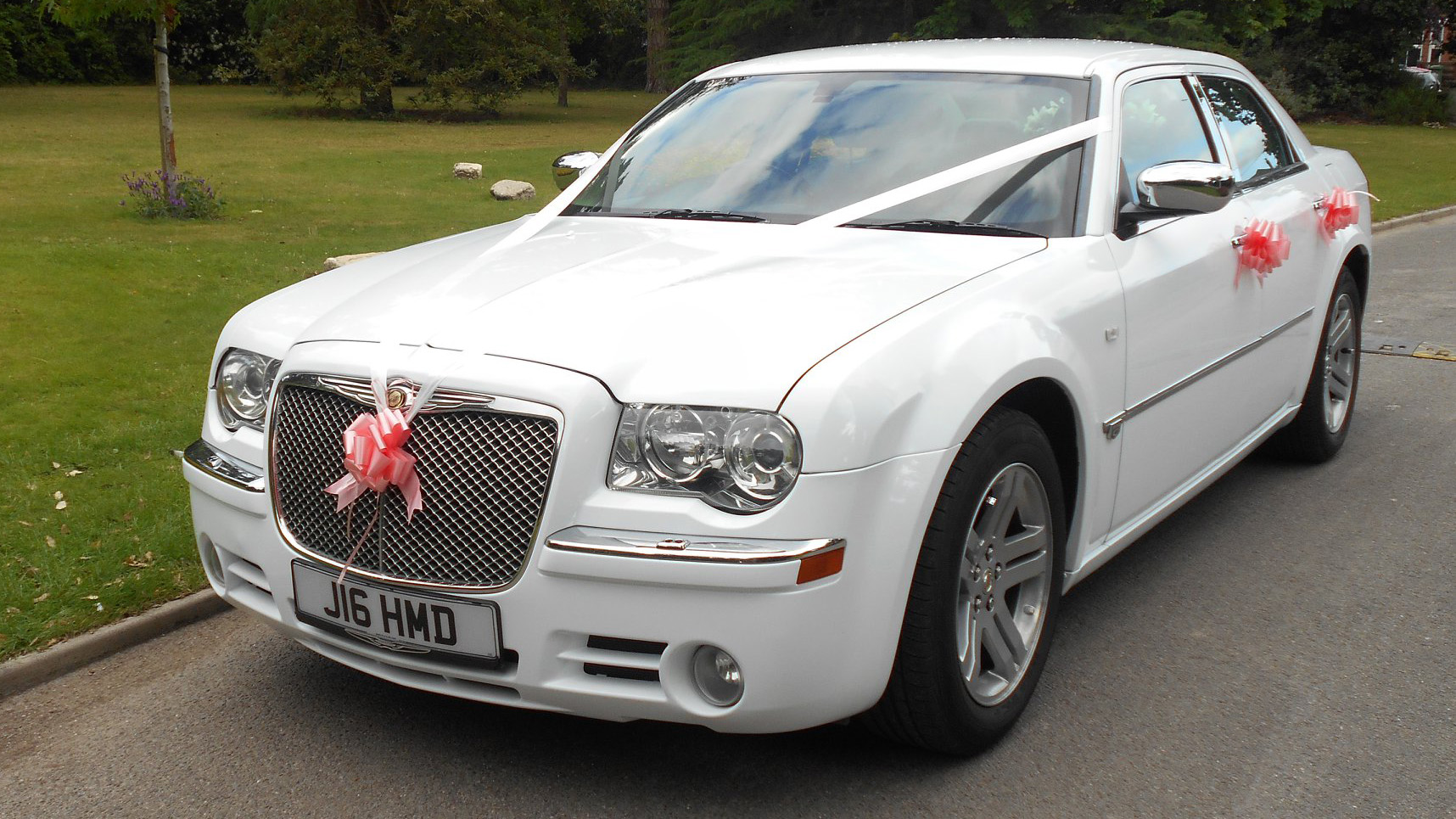 Whhite Modern Chrysler 300c saloon car with Pink Ribbons and Bows