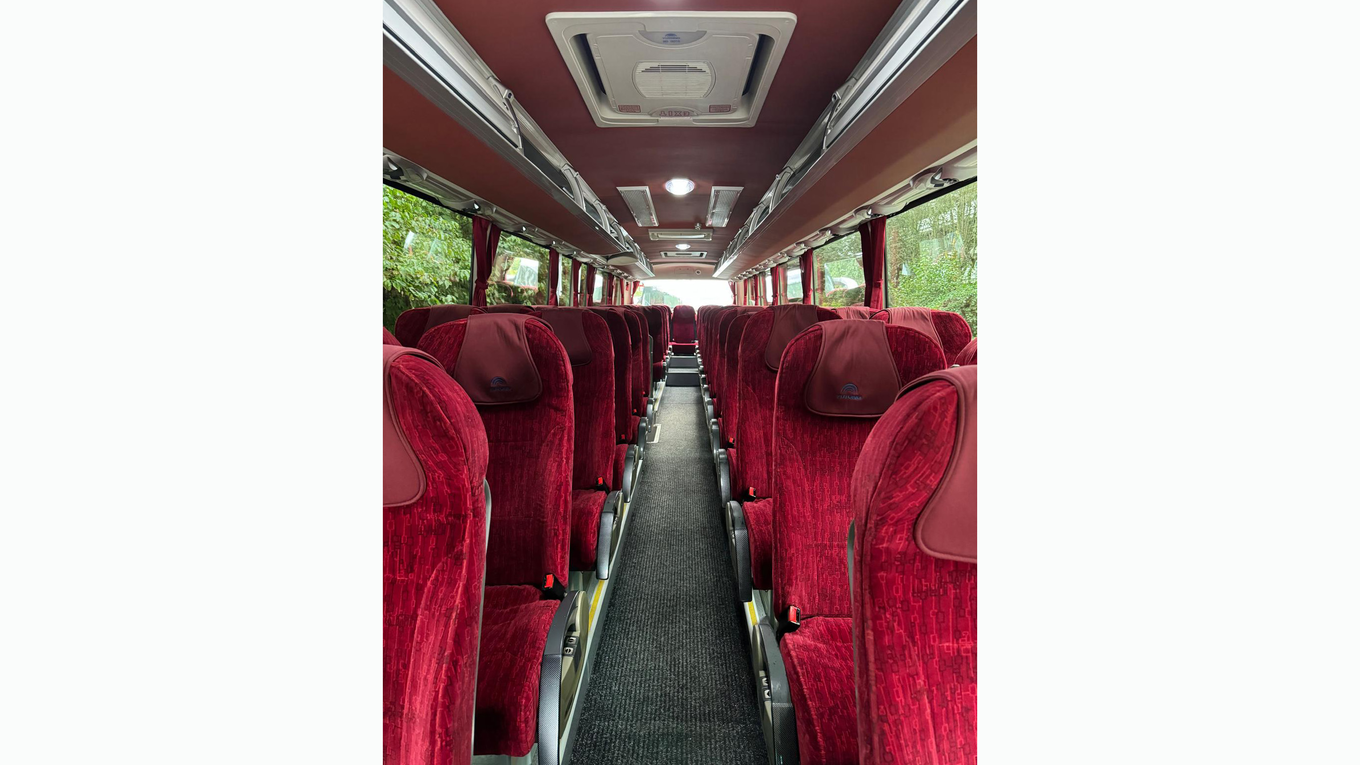 Burgundy seats inside a 55-seater modern Coach